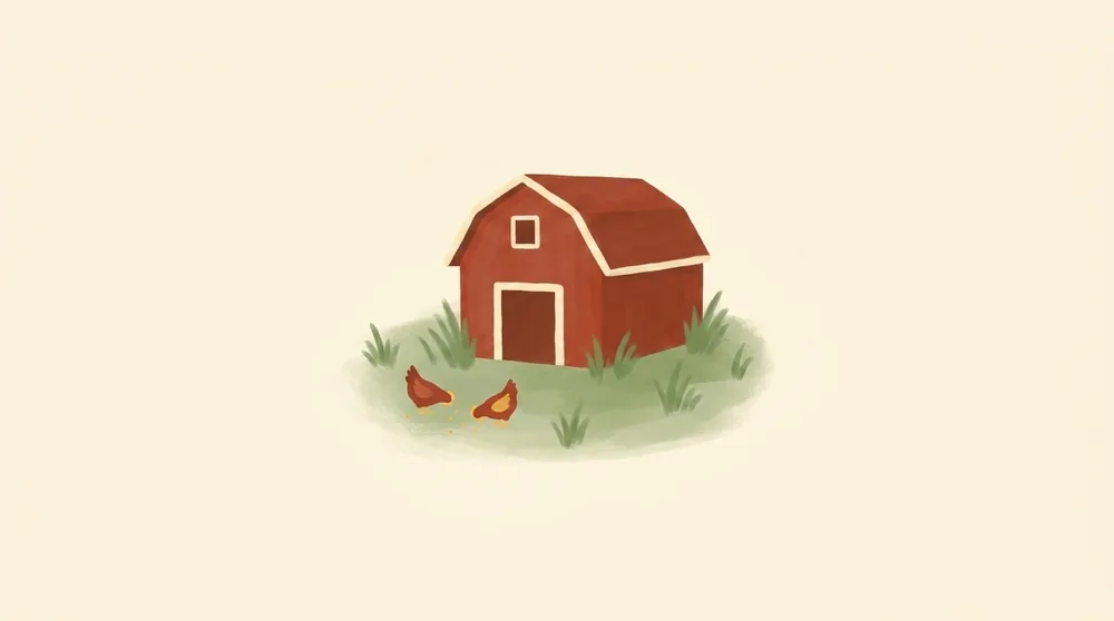 A small red barn in a green field at morning